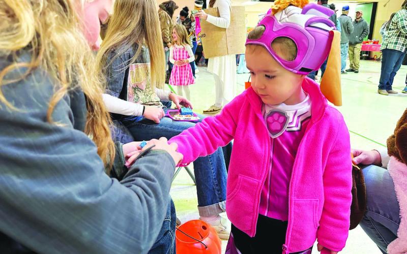 Payton Bollinger, daughter of Shad Bollinger and Kelly Laurenz, was ready for trick-or-treating in her Paw Patrol costume, while getting a temporary tattoo at the Dewey County 4-H Halloween Carnival in Timber Lake on Sunday, Oct. 29. Turn to Page 9 for more photos from the carnival. Photo by Kathy Nelson