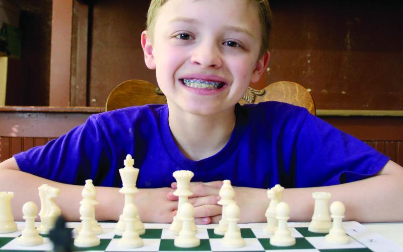 Ben Mareska, 10, took up the game of chess about a year-and-a-half ago after learning how to play the game watching YouTube videos. Today, the Timber Lake Elementary School fourth grader is halfway to becoming a Grand Master, the highest level of player aside from World Champion. Photo by Jon Flatland