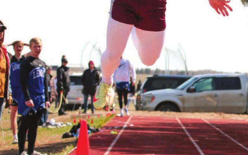 Timber Lake senior Hank Kraft leaps for a triple jump mark during the Timber Lake Invitational meet April 26. Photo by Jon Flatland