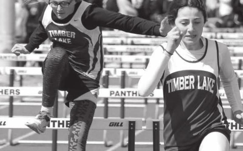 Timber Lake hurdlers (L-R) Lexi Locken, Ruby Maher, Jaycie Lemburg and Kamee Mareska concentrate during their heat at the Timber Lake Invitational meet held April 26. Photo by Jon Flatland