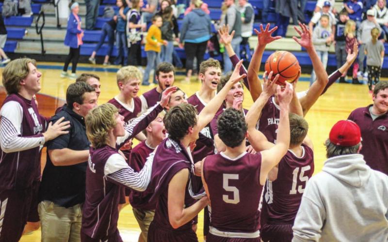 The Timber Lake boys basketball team celebrates its Region 8B finals victory over Lemmon. Photo by Jon Flatland