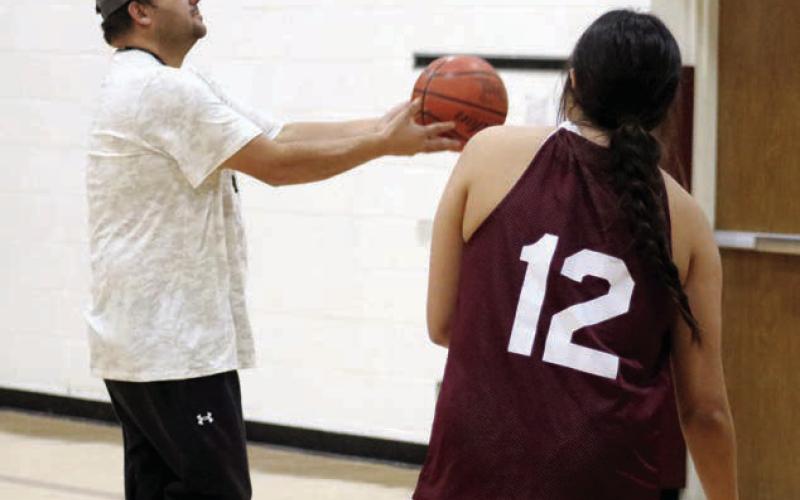 New Timber Lake girls basketball coach Tuffy Thompson works with senior Kessa Bigger under the basket during practice on Monday, Dec. 2. The Lady Panthers open their 2024-25 season on Friday with a road trip to Groton. They follow that with a trip to Wakpala on Tuesday, Dec. 10. Photo by Jon Flatland