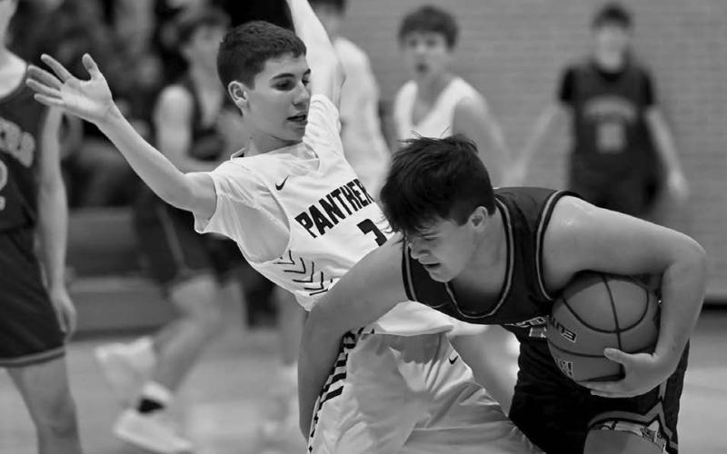 Timber Lake’s Braden Lawrence (left) applies some pressure to a New Underwood ball handler during boys basketball action before the holiday break. Topic photo by Marie DuPreez