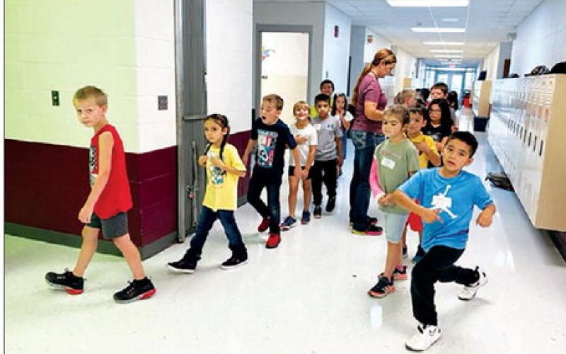Second graders line up with the help of teacher Shanna Gebhardt on the first day of school at Timber Lake Elementary. Enrollment in the elementary school was at 196 the first week, up 30 from last year.