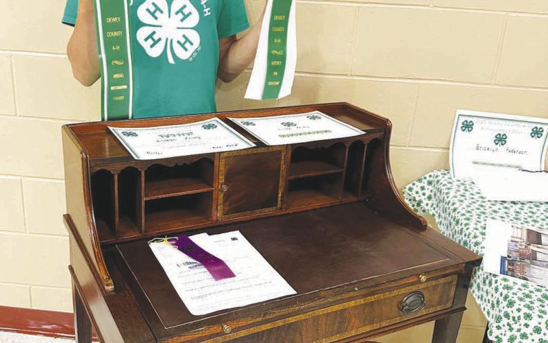 An antique desk found at a garage sale was transformed into a masterpiece by Isaac Zeug, who won the award for Overall Outstanding 4-H project at the Dewey County Fair.