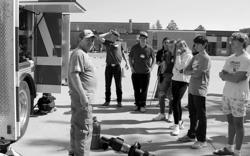 Grady Kraft of the Timber Lake Fire Department answers questions about the department’s trucks and geat from students participating in the Freshman Impact program at the Timber Lake School on Monday, Sept. 16. Also involved in the program was the Isabel Fire Department. Photo by Jon Flatland