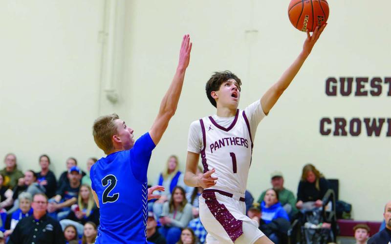 Timber Lake forward Jackson Bigger drives past Lemmon’s Drew Hetzel for a layup during the Panthers’ win over the Cowboys in the boys basketball season opener last Friday, Dec. 19. Bigger finished the contest with 13 points. Topic Photo/Marie Du Preez