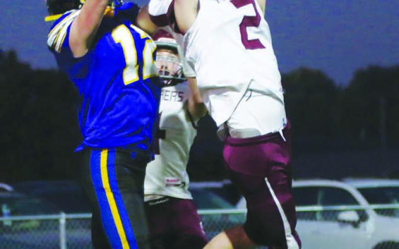 Cole Ducheneaux (2) outleaps Castlewood receiver Jackson Schofield (12) to intercept a pass in the end zone during Timber Lake’s 26-0 loss to the Warriors in the first round of the Class 9A football playoffs last Thursday, Oct. 20. Giving defensive help on the back side is Gracen Hansen. Photo courtesy of LeeAnne Dufek, Hamlin Co. Publishing