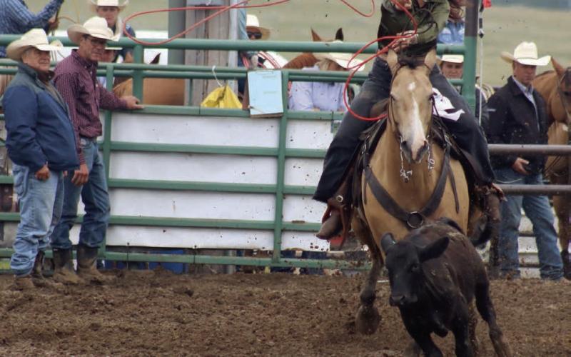 Acacia Anderberg of Mobridge throws her rope as she competes in the ladies breakaway event at the Isabel Rodeo on Saturday, Aug. 2. High winds, torrential rain and lightning forced the postponement of Friday night’s rodeo action until Saturday afternoon. Photo by Jon Flatland