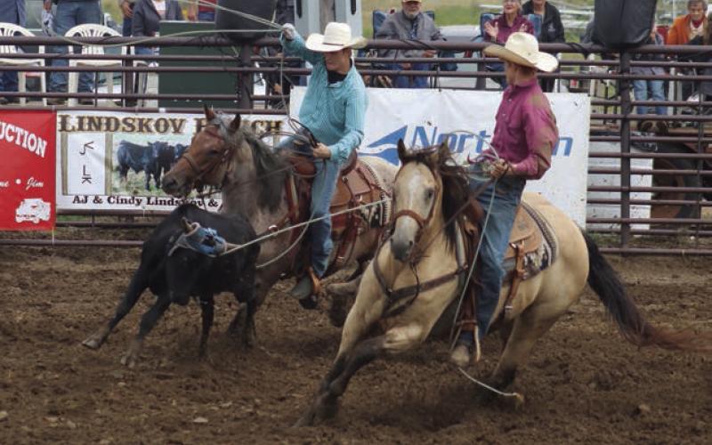 Sage Burress of Isabel and Tyan Johnson of Sisseton clocked a time of 9.8 seconds to place sixth overall in the team roping event at the Isabel Rodeo. Photo by Jon Flatland