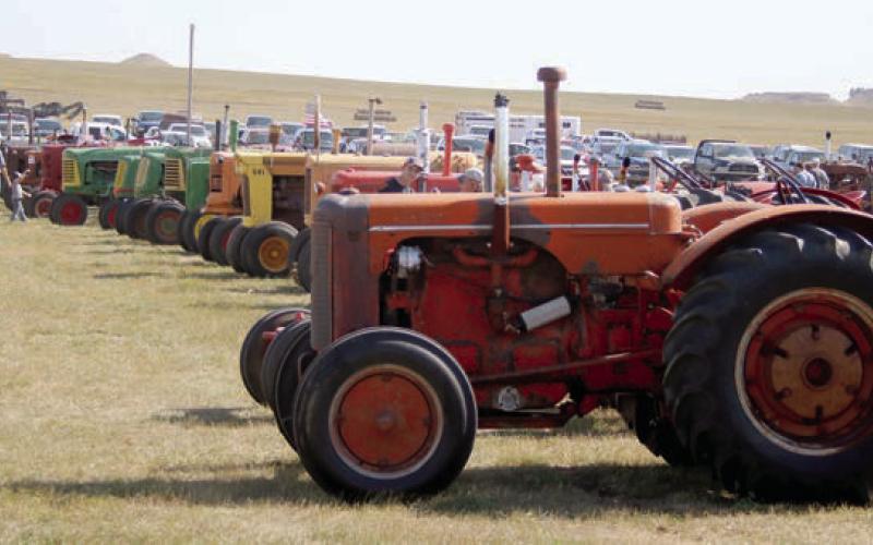 Visitors to this year’s Coal Springs Threshing Bee &amp;amp; Antique Show take in one of the buildings containing old gas pumps, oil and gas signs, barber chairs and more. At right, several long rows of tractors were on display for this year’s guests and parades held each day of the event featured more than 50 units. Look for a lot more photo coverage on the Timber Lake Topic Facebook page! Photos by Jon Flatland