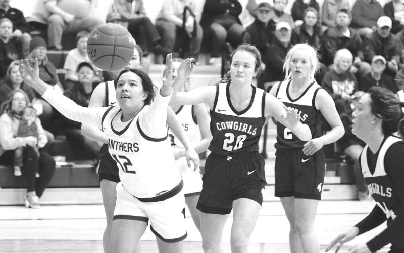 Timber Lake center Kessa Bigger (12) scrambles for a rebound during action against Lemmon last Friday, Dec. 9. Looking on are Lemmon defenders (l-r) Kelly Lynch, Allie Kohn and Emily Faughn. Timber Lake claimed a 59-43 victory to improve to 2-0. Photo by Jon Flatland