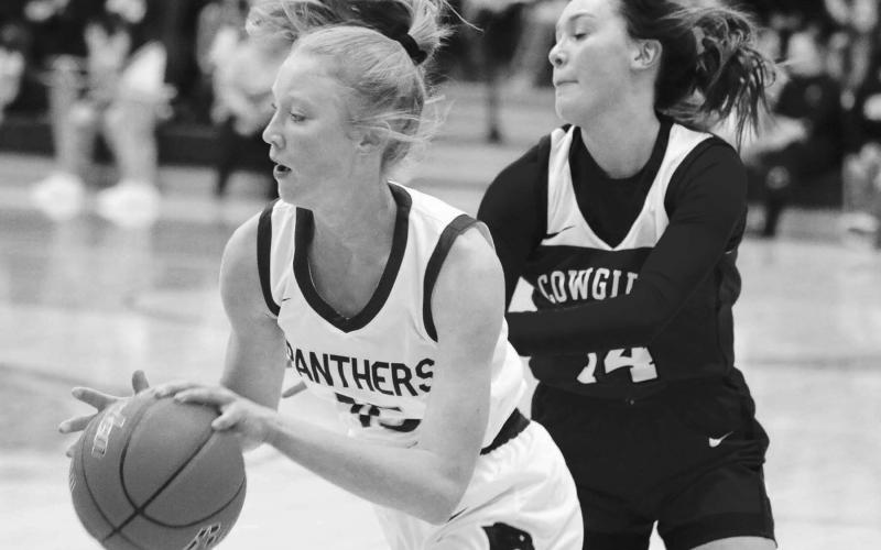 Junior forward Kendyl Locken drives past Lemmons Emiliy Faughn during Timber Lakes 59-43 win over the Cowgirls last Friday, Dec. 9. Locken scored five points and pulled down two rebounds in the matchup. The Lady Panthers will take on Strasburg-Zeeland (ND) on Saturday, Dec. 17, at the Mobridge Rotary Classic at Mobridge-Pollock High School. Photo by Jon Flatland