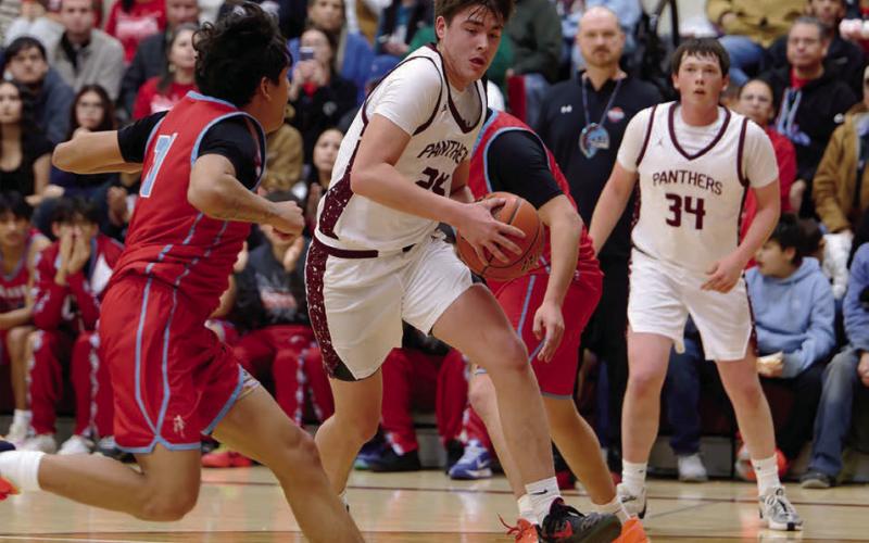 Kanton Hunt drives past a C-EB defender on his way to the hoop during the Panthers’ loss to the Braves that included 15 three-pointers. Hunt finished with a game-high and career-high 32 points. Rance Martin (34) iooks on after collecting an assist on the play. Topic Photo/Marie DuPreez