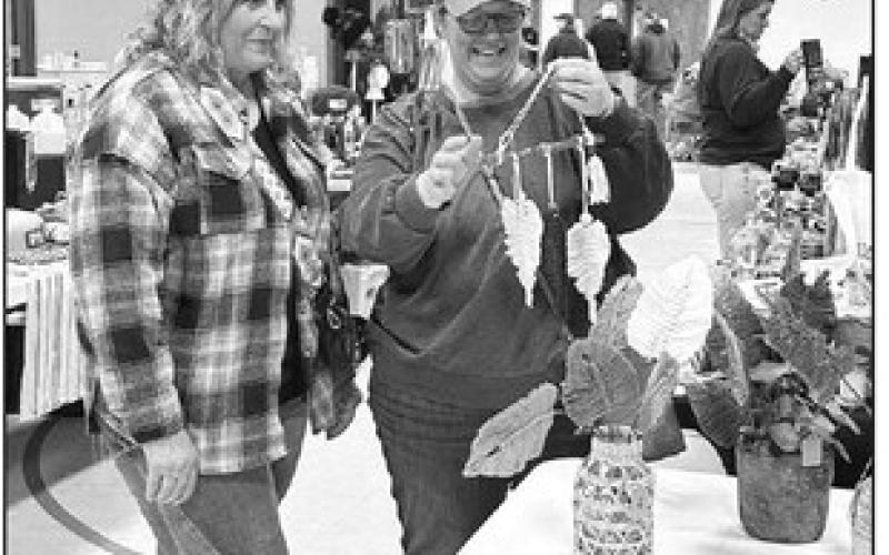 Nancy Olson of McIntosh, left, shows a piece of macrame from her vendor table to Julie Marshall of Timber Lake at the Timber Lake Holiday Craft Fair held Saturday, Nov. 2, at the Timber Lake Community Center.