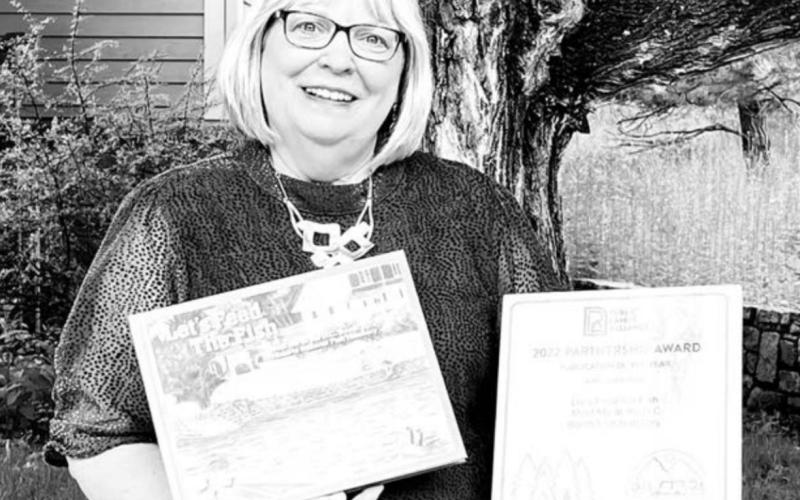 Karen Dahlgren Holzer, Booth Society Executive Director, shows the award from Public Lands Alliance for “Let’s Feed the Fish - Meet Me at the D.C. Booth Historic National Fish Hatchery.” The book was published and marketed by the Booth Society, the nonprofit friends group of the D.C. Booth Fish Hatchery in conjunction with the hatchery’s 125th anniversary. Holzer is a 1977 graduate of Timber Lake High School.