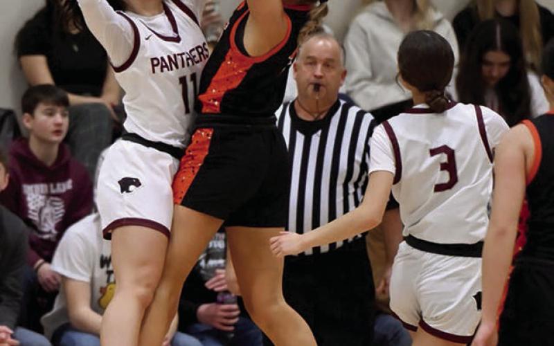 Timber Lake’s Kiya Mowrer (11) blocks a shot attempt by Ipswich guard Brianna Geditz while Natalie Lawrence (3) and the official look on. Photos by Maria DuPreez