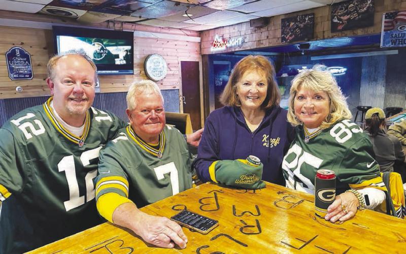 Several Green Bay/Tucker Kraft fans from Wisconsin drove to Timber Lake to watch the Packers game with other fans at The Corner Bar and Grill on Monday night. Pictured with Tucker’s grandmother, Linda Kraft (in blue), are (l-r) Steve Wikel of Waupaca, WI and Ottis and Sue Smith of Grand Chute, WI. Although Tucker is out for the season with an injury and the Packers lost to the Philadelphia Eagles 10-7, the Wisconsin fans said it was worth the 1200 mile trip.