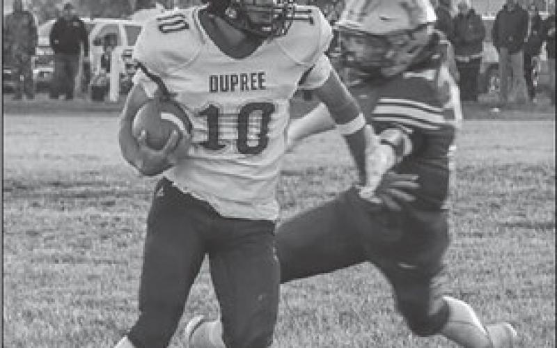 Tre White Wolf (10) spins away from a would-be tackler during Dupree’s 50-28 upset of Harding County/Bison in the first round of the State Class 9A football playoffs. White Wolf rushed for 41 yards and a touchdown in the victory. Photo by Spencer Olsen