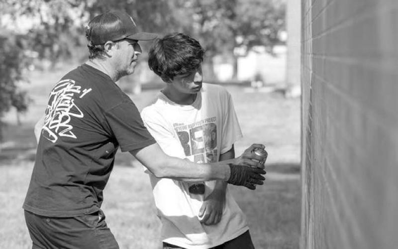 A mural artist teaches can control skills in the Waniyetu Wowapi Art Park in Eagle Butte during the 2025 RedCan Graffiti Jam last week. During the event, teen art interns and Lakota Art Fellows were paired with headlining artists who served as instructors and mentors. Photo courtesy of Cheyenne River Youth Project