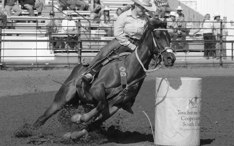 Maddie Gray of Ridgeview leans her horse around a barrel during Saturday morning action in Ft. Pierre.