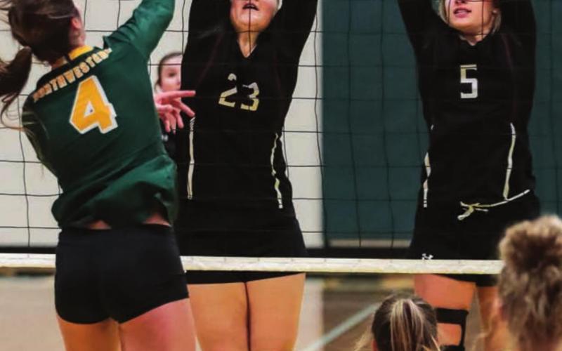 Timber Lake’s Stormi Hulm (23) and Shay Kraft (5) try to block Northwestern’s Hannah Schentzel.