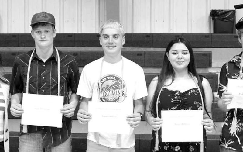 Mandi Smith (left) presented $500 DHS Alumni Scholarships to these four seniors (l-r): Cruz Birkeland, Spencer Olsen, Keyra Jeffries, and Fletcher Birkeland.