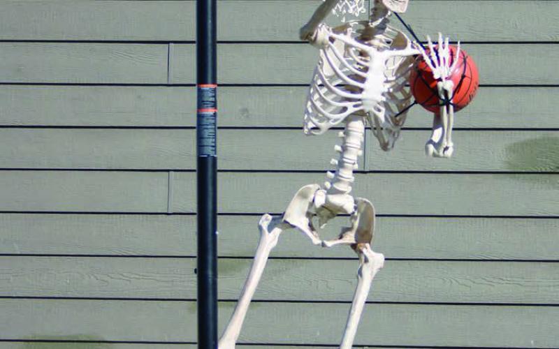 With Halloween and hoops season just around the corner, a skeleton hangs around the Brent and Kaleigh Biegler residence in Timber Lake looking for a game of “horse.” Photo by Jon Flatland