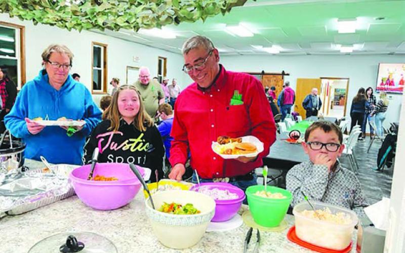 A bounteous buffet of wild game and other foods was served. L-R are Bonita Richter, Ronnilyn Long, Wade Lawrence and his grandson Joseph Bridges. Photos by Kathy Nelson
