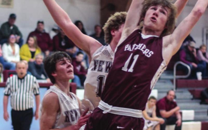 ABOVE: Chase Marshall (11) reaches for a rebound against Newell.