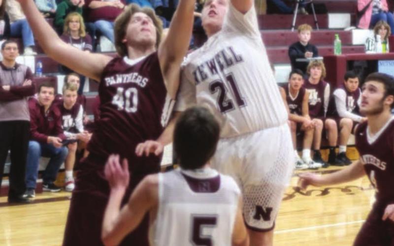 RIGHT: Nate Schaffer (40) fights with Newell’s Colton Burtzlaff (21) for a loose ball during their game last week.