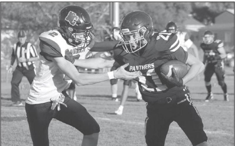 Timber Lake wide receiver Eddie Keller stiff-arms a would be North Central defender during football action at Kraft Field last Friday, Sept. 6. Keller shed the tackler and turned this short reception from quarterback Cole Ducheneaux into a 50-plus yard touchdown. Photo by Jon Flatland