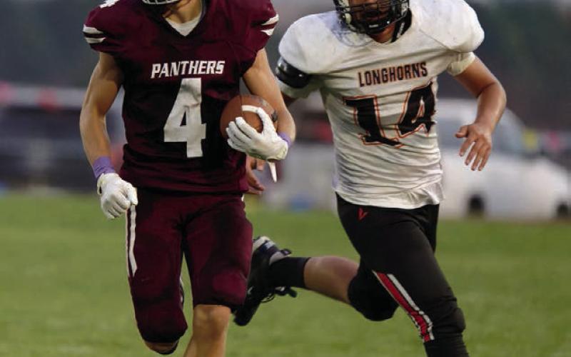Broc Bauer (4) had a big night last Friday, catching two TD passes and racking up 300 all-purpose yards in Timber Lake’s win over the Faith Longhorns. Photo by Marie Du Preez