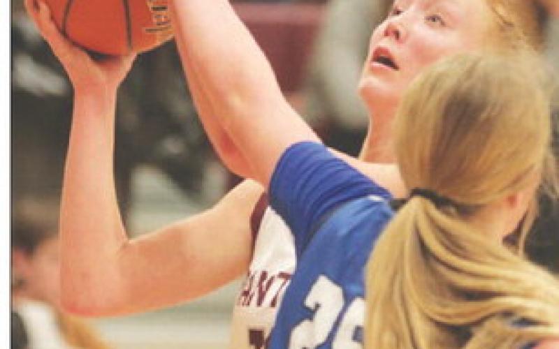 Junior forward Kendyl Locken is fouled by Lemmon’s Madison Dauwen (25) on a drive to the basket during semifinal round action of the 2023 LMC Girls’ Basketball Tournament Friday in Timber Lake. The Cowgirls sank 14 three-pointers to upset the top-seeded No. 3 ranked Lady Panthers 79-54. Photo by Jon Flatland