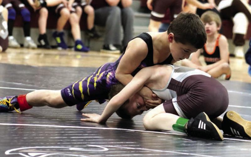 Rowdy Schrempp of Dupree (top) presses a hold on Lincoln Aberle of Timber Lake during recent youth wrestling triangular action. Schrempp will compete in the SDWCA State Wrestling Tournament this weekend in Rapid City. Photo by Jon Flatland