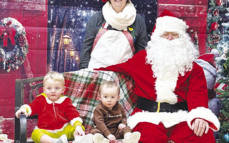 Checking out Santa (and keeping an eye on their parents and the photographer) are cousins Hayes Hansen, son of Lexy and Trenton Hansen, and Cash Harrison, son of Josie White and Jackson Harrison.