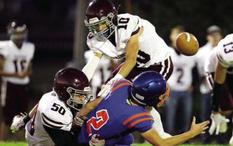 Landon Lemburg (50) and Gavin Farlee (10) force a fumble while bringing down a Stanley County ball carrier in action earlier this season. The Panthers finished the season 4-5 overall after being eliminated from the playoffs last Thursday. Photo courtesy of 605 Sports