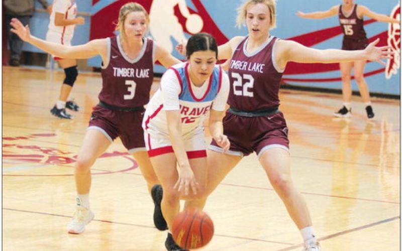 Timber Lake’s Carlie Lawrence (3) and McKenzi Vomacka (22) pressure Cheyenne-Eagle Butte’s Tiana Johnson during the Lady Panthers 56-30 win over the Lady Braves last Friday, Feb. 17, in Eagle Butte. Timber Lake closed its regular season at 14-5 and is the No. 1 seed in the Region 8B Tournament. Photo by Jon Flatland