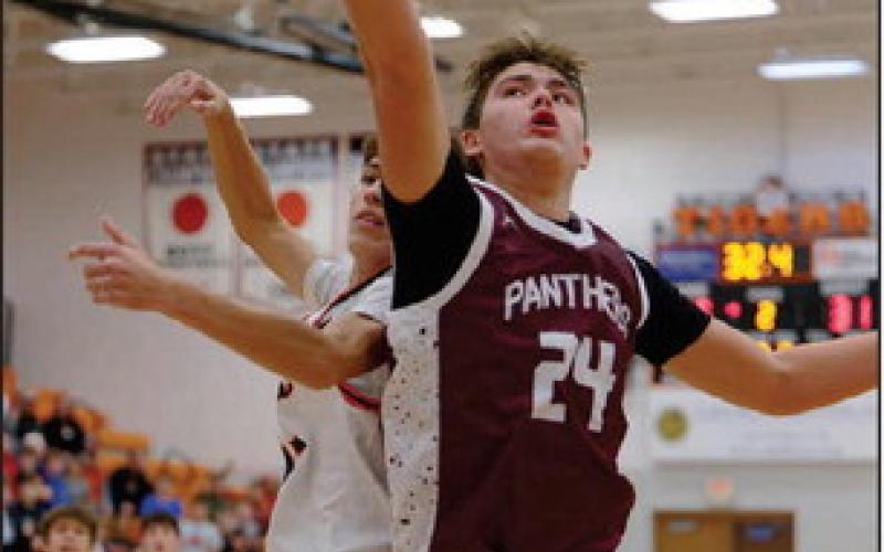 Left, Timber Lake’s Kanton Hunt (24) battles an unidentified defender for a rebound duing the Panthers ‘matchup with Mobridge-Pollockon Dec.16. Topic Photo/Marie DuPreez