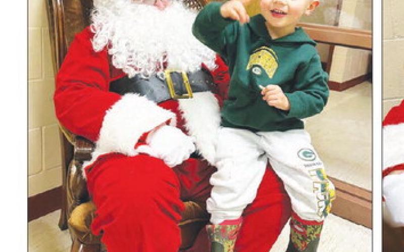 Santa Claus entertained kids at Timber Lake’s Christmas Extravaganza on December 1. AT RIGHT: Dougie Kraft, son of Tanner and Sierra Kraft, tells Santa what he wants fro Christmas: “Dinosaur eggs!” FAR RIGHT: Hooley and Kaz Lamb, children of Kritter and Kamy Lamb, pose for Mom’s camera.