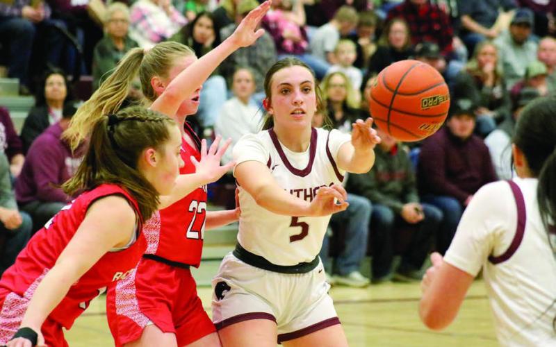 Timber Lake senior McKenzi Vomacka fires a pass to a teammate while being pressured by a pair of Potter County defenders during girls basketball action last Friday. The Lady Panthers won three games last week to improve to 6-3 overall. Photo by Jon Flatland