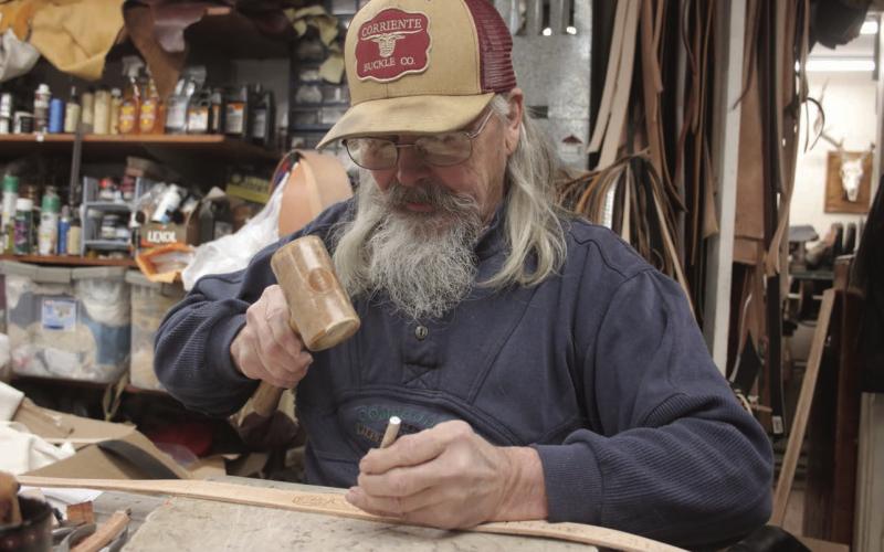 John Bachman, owner of the Eagle Butte Saddle Shop, has spent the better portion of his life working with leather. Photo by Jon Flatland