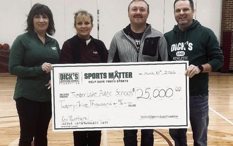 The Timber Lake School District was recently awarded a $25,000 donation from the DICK’s Sporting Goods Foundation to be used for purchasing wrestling mats and upgrading volleyball equipment. Pictured (l-r) are TLHS alum Randi Aberle, Supt. Lori Enright, wrestling coach Sawyer Sandquist, and Michael Shaughnessy, manager of DICK’s Sporting Goods in Bismarck, ND.