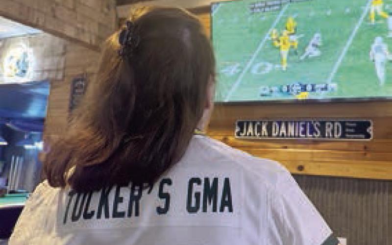 Linda Kraft, Tucker Kraft’s grandmother, watches him on the television at The Corner Bar &amp;amp; Grill.
