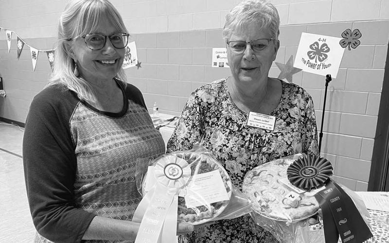 Diana Aberle (left) baked the reserve champion pie at the Dewey County Fair, and Dawn Leibel won the grand champion ribbon and cash award for her pie and reserve champion for her cookies.