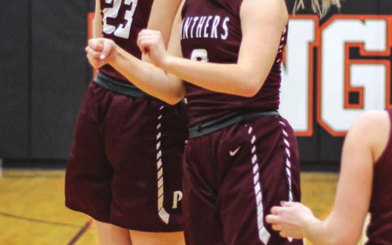 TLHS seniors Stormi Hulm (23) and Tia LeBeau have fun pre-game.