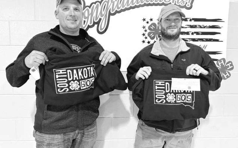 Bo Biegler and Kyle Nilson were presented with sweatshirts in recognition of their role as 4-H volunteers with the shooting sports program.