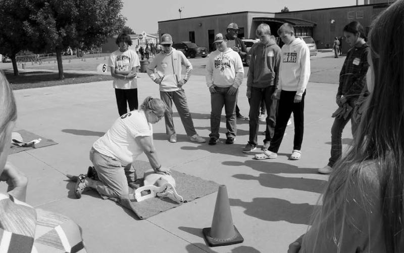 EMT and Timber Lake Ambulance Squad member Teri Gayer demonstrates life-saving techniques at one of the stations visited by students from eight area schools as part of the Freshman Impact program in Timber Lake last week.