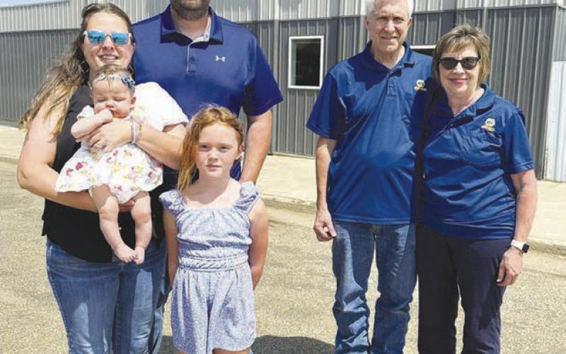 Max and Pam Schott (left), with daughters Grace and Remy, are the owners of Schott Sales, LLC, formerly Biegler Equipment in Timber Lake. The Schotts say they want to continue the same service that Bart and Marlene Biegler (right) have provide to customers for 37 years. You can watch for Schott’s Sales in the Days of 1910 parade on Saturday. Photo by Kathy Nelson