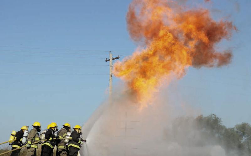 About 70 firefighters from area communities took part in a Northwest District Fire School in Isabel on Sunday, Sept. 21. Firefighters trained on handling propane fires, wildland firefighting techniques, vehicle extrication, and electrical fires and safety. Photo by Jon Flatland